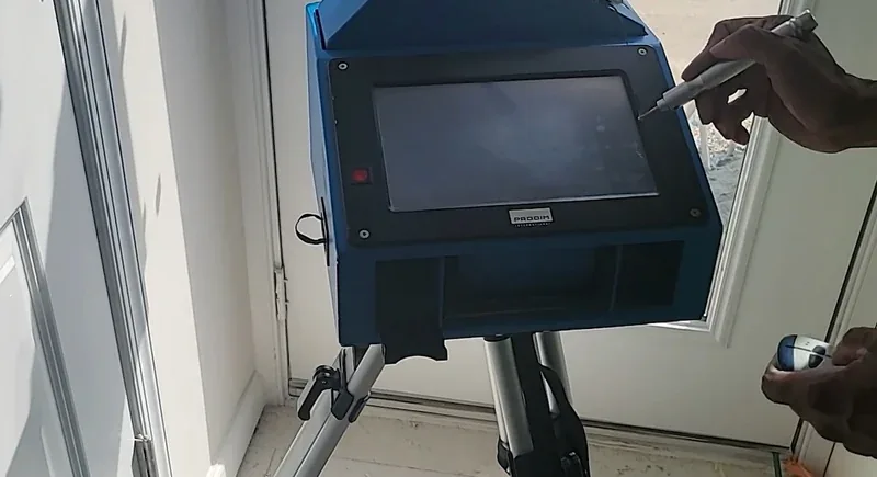 Technician capturing exact countertop site dimensions with digital measuring equipment
