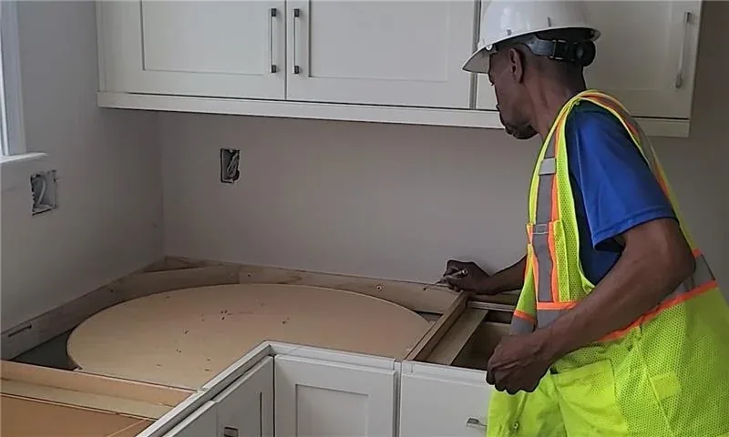 Artelye installer working carefully at a countertop installation