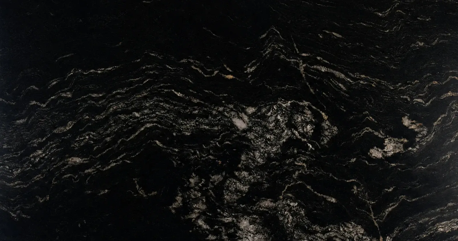 Titanium granite with dark mineral movement and warm gold veining