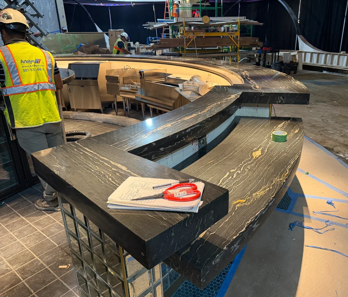 Artelye installation work around the curved natural-stone bar at MD Live Casino