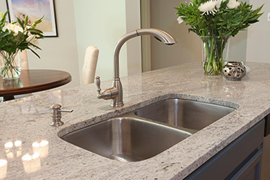 Granite topped kitchen island with a sink