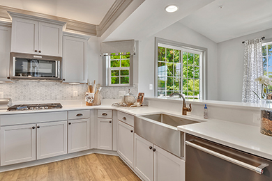 Bright kitchen with large island, white quartz countertops